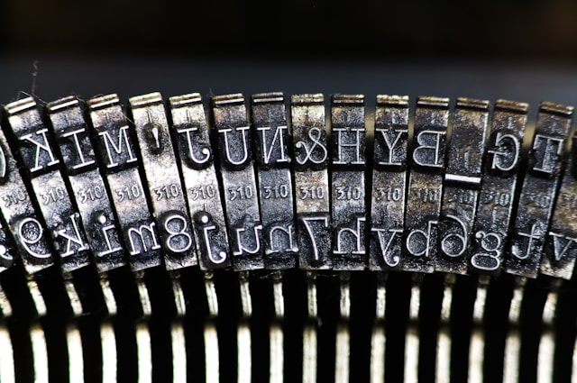 Closeup reverse image of steel typewriter keys.