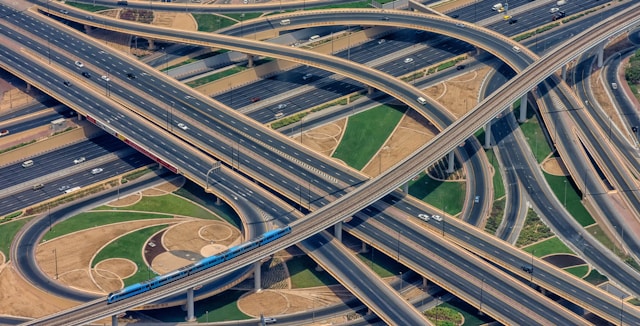 Metropolitan highway system with on- and off-ramps and vehicles traversing on them.