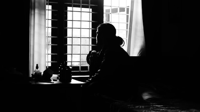 The Dark Night of the Soul is aptly named. Acting out this moment puts you the closest you'll ever come to your character. Black-and-white photo of a person in profile sitting in front of a window.